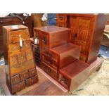 A Japanese elm cabinet, an elm cabinet of drawers of tapered form and two 'stepped' cabinets Largest