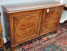 A George III mahogany estate cupboard with panelled doors W.140cm