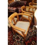 A set of four Arts & Crafts style oak elbow chairs