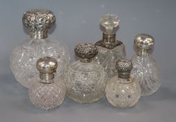 A large late Victorian silver mounted cut glass scent bottle and five other scent bottles.