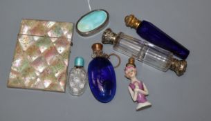 A 1930's silver and enamel pill box, four assorted mounted glass scent bottles including enamel, a