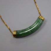 A gold and green hardstone pendant, stamped 14k