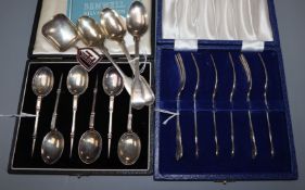 A cased set of six silver mote spoons, a cased set of six silver cake forks, three teaspoons and