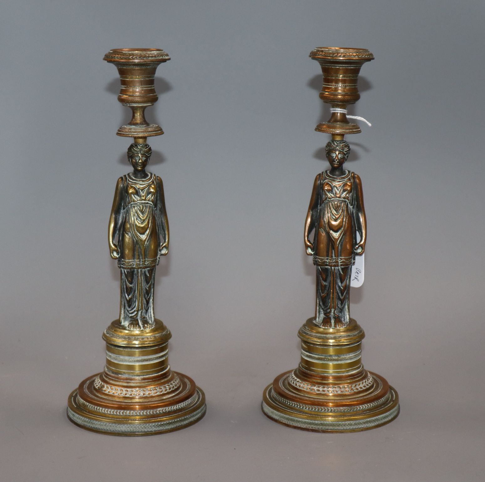 A pair of 19th century bronze 'caryatid' candlesticks