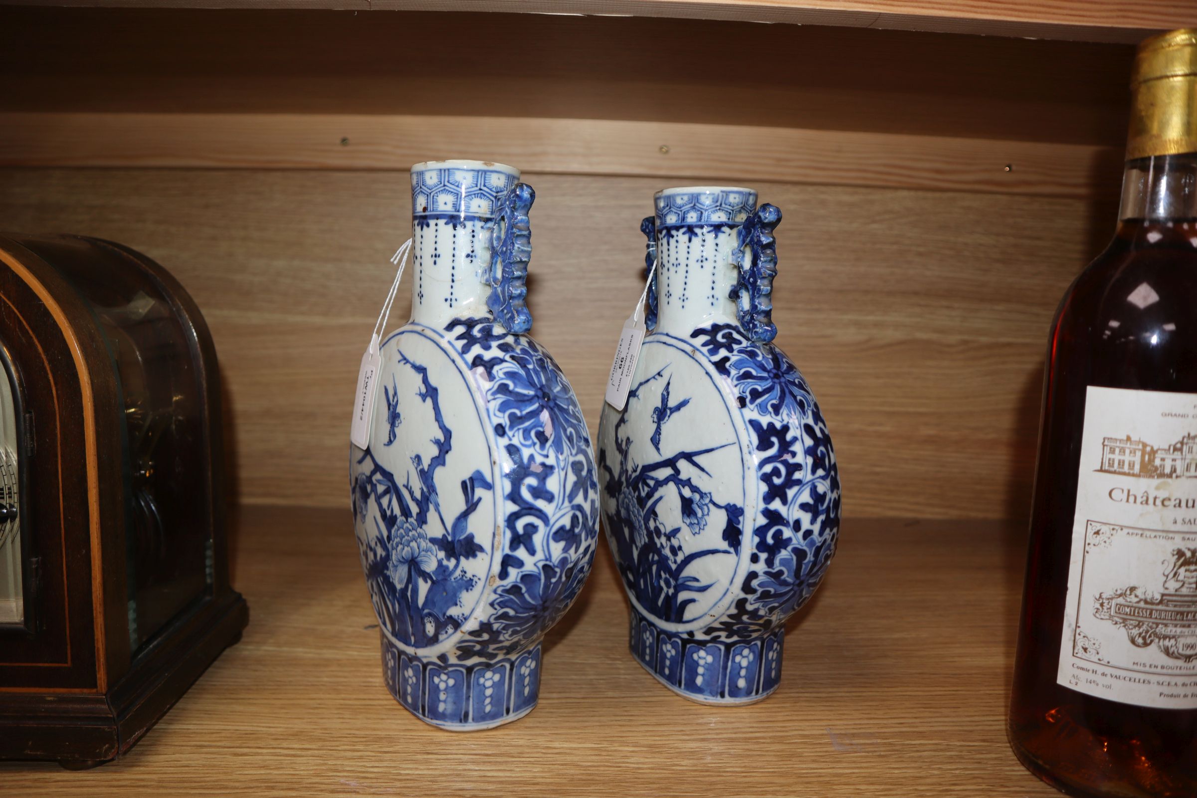 A pair of 19th century Chinese blue and white moon flasks, Kangxi marks, decorated birds and - Image 8 of 11