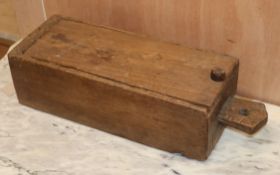 A teak dug-out box, sliding lid L.54cm