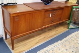 A teak sideboard fitted drawers and cupboards