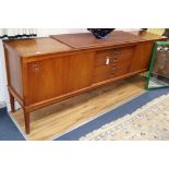 A teak sideboard fitted drawers and cupboards