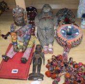 Two head dresses, an Indian carving, an Indian puppet, another Indian headdress, a wooden puppet and