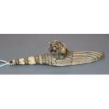 A good Japanese ivory paper knife, Meiji period, carved as a kitten seated upon a giant feather