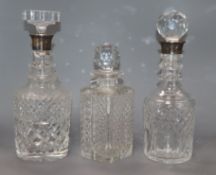 Two silver mounted cut glass decanters and another cut glass decanter