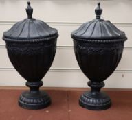 A pair of cast iron urns and covers height 37cm