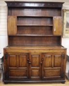 An 18th century and later panelled oak dresser, with boarded rack W.171cm