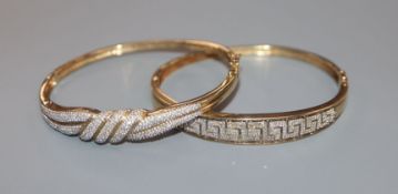 Two modern yellow metal and pave set diamond hinged bracelets, gross 26.7 grams.