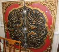 A carved Chinese style painted wood and composition two section panel decorated with mythical