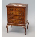 A miniature walnut chest on stand height 29cm