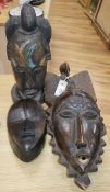 Two tribal carved masks and an African carved wood mask