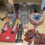 Two head dresses, an Indian carving, an Indian puppet, another Indian headdress, a wooden puppet and