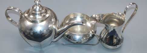 A Persian white metal three piece tea set and pair of sugar tongs, gross 818 grams.