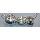 A Persian white metal three piece tea set and pair of sugar tongs, gross 818 grams.