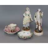 A pair of Dresden figures of a lady and gallant and a pink glazed cup and saucer and a dish