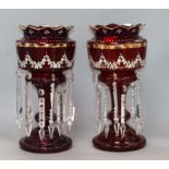 A pair of cranberry glass lustres height 37cm