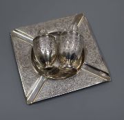 A Persian white metal engraved ashtray and a Persian engraved white metal salt and pepper pot, 219