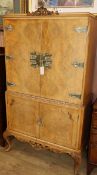 A 1950's burr walnut cocktail cabinet W.89cm