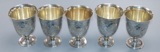 A set of five Persian engraved white metal stem cups, height 86mm, 486 grams.