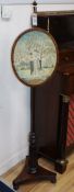 A Regency mahogany pole screen, with oval silkwork banner H.132cm