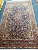 A Kashan red ground rug 212 x 130cm