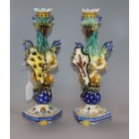 A similar pair of Cantagalli maiolica 'griffin' candlesticks height 34cm