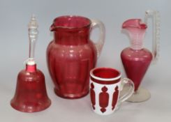 A ruby overlaid glass mug, a cranberry ewer, jug and a bell