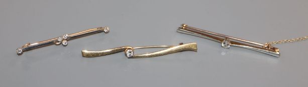 Three assorted diamond set bar brooches, including 15ct and 18ct gold, largest 56mm.