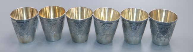 A set of six Persian engraved white metal beaker cups, height 7cm, 562 grams.