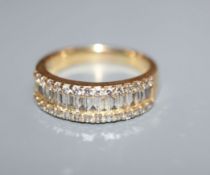 A modern 18k yellow metal and channel set baguette cut diamond set half hoop ring, with brilliant