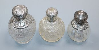 Three assorted silver or white metal mounted cut glass scent bottles, including Saunders & Shepherd,