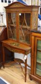 An Edwardian Sheraton Revival painted and decorated display cabinet on stand W.150cm