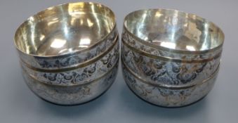 A set of six Persian engraved white metal finger bowls, 11.4cm, 998 grams.