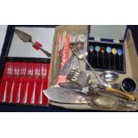 A cased set of six silver and polychrome enamel coffee spoons and a quantity of assorted plated