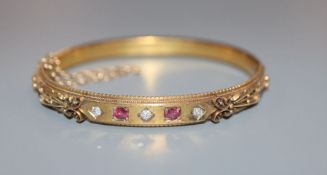 An Edwardian 15ct, ruby and diamond set hinged bracelet, gross 11.6 grams.