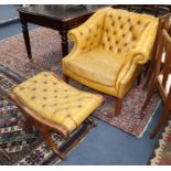 A pair of buttoned pale tan leather library chairs and footstool