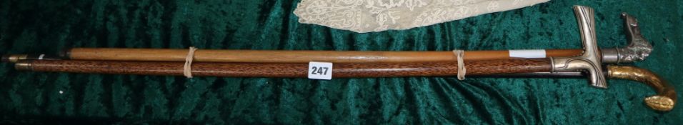 Three metal mounted walking sticks