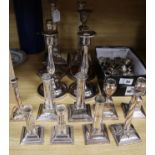 Four pairs of silver plated candlesticks, seven singular and sconces