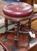 A Victorian adjustable music stool with hide-covered seat