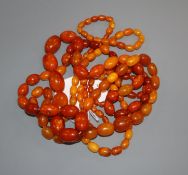 A single strand graduated amber bead necklaces and one other necklace containing amber and simulated