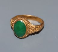 A Chinese yellow metal and cabochon jade set dress ring, with closed back setting stamped with