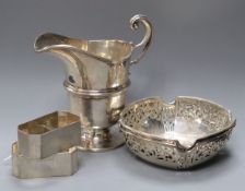 A pair of silver bon bon dishes, a pair of napkin rings and a cream jug.