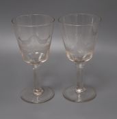 A pair of wheel engraved glass goblets height 20cm