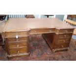 An early 20th century oak pedestal partner's desk W.186cm